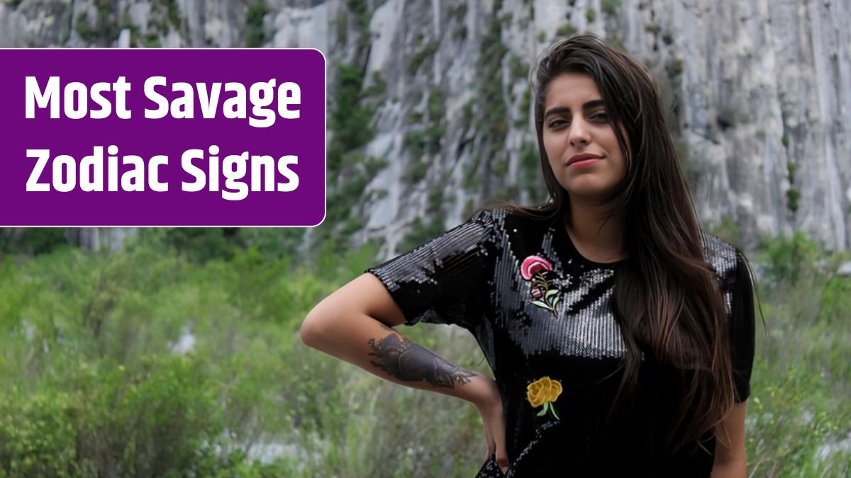 Beautiful young woman standing against plants.