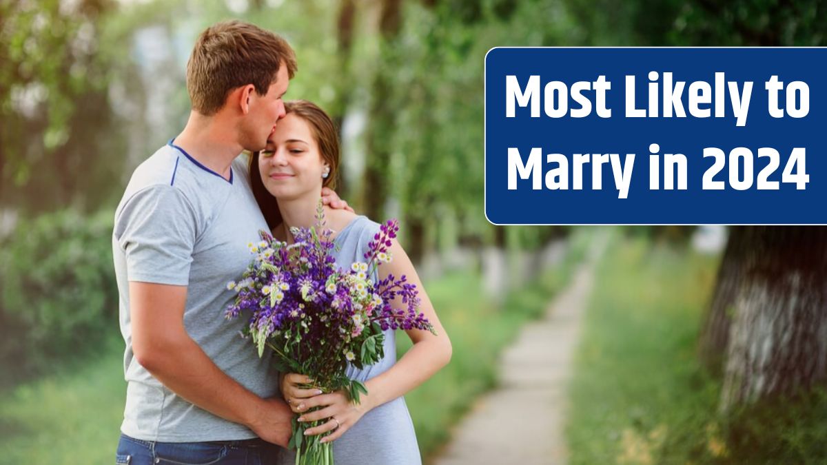 Young couple in love with a bouquet of flowers on a background of the path.